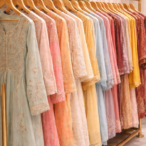colorful kurtis hanging neatly in an organized boutique studio setting